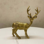Side profile of a textured antique brass deer figurine displayed on a white marble surface