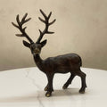 Handcrafted brass deer sculpture on white table