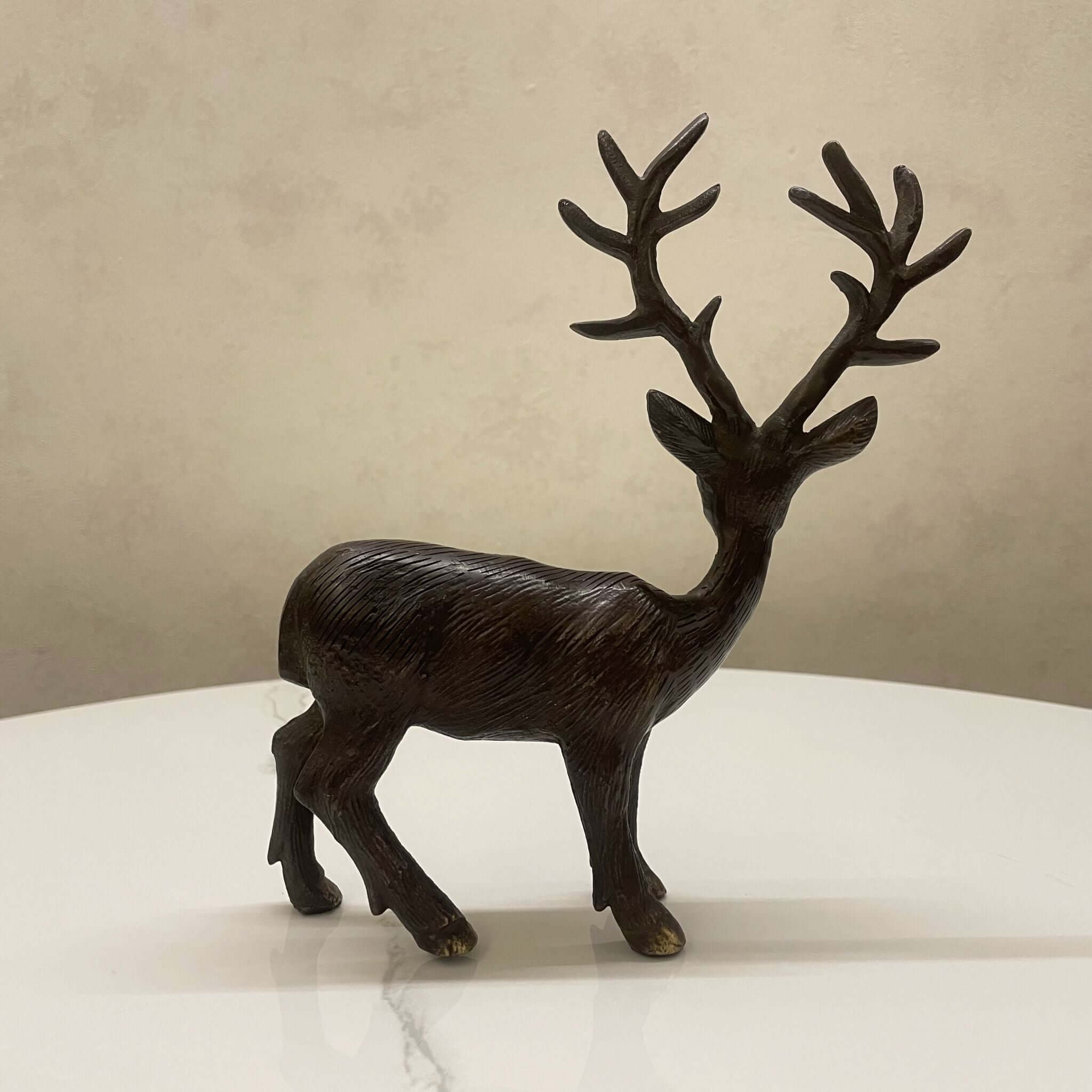 Detailed brass deer statue with antlers

