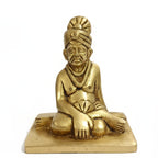 Golden brass Swami Samarth Murti idol isolated on white background